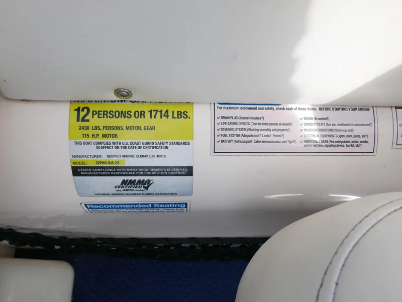 Slide: The Image of Capacity label on a 2006 Sweetwater SW2222DF boat, seating for 12 persons or 1714 lbs. - 15