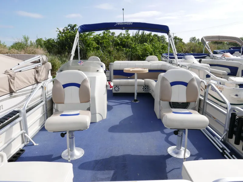 Slide: The Image of 2006 Sweetwater SW2222DF pontoon boat with blue carpet and white seating. - 4