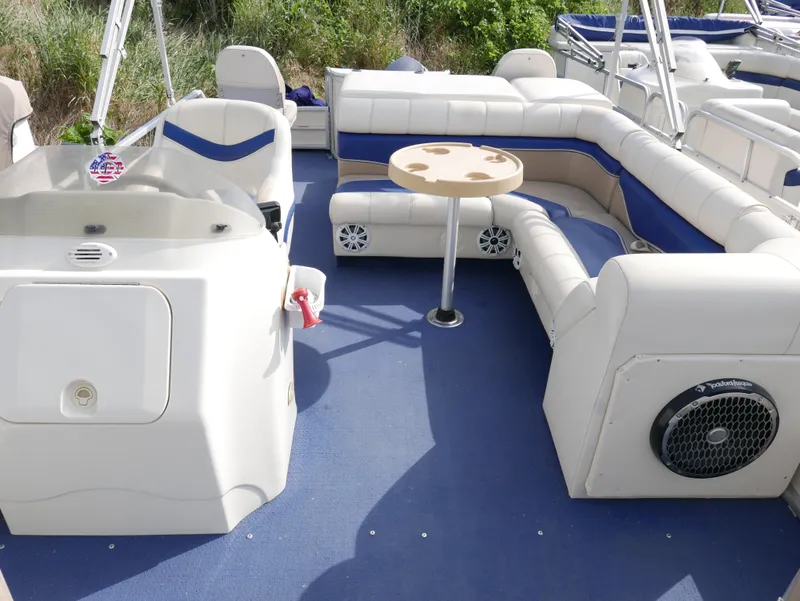 Slide: The Image of 2006 Sweetwater SW2222DF pontoon boat interior with blue and white seating and table. - 7