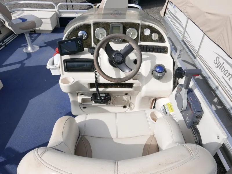 Slide: The Image of 2006 Sweetwater SW2222DF boat dashboard with steering wheel, gauges, and navigation equipment. - 9
