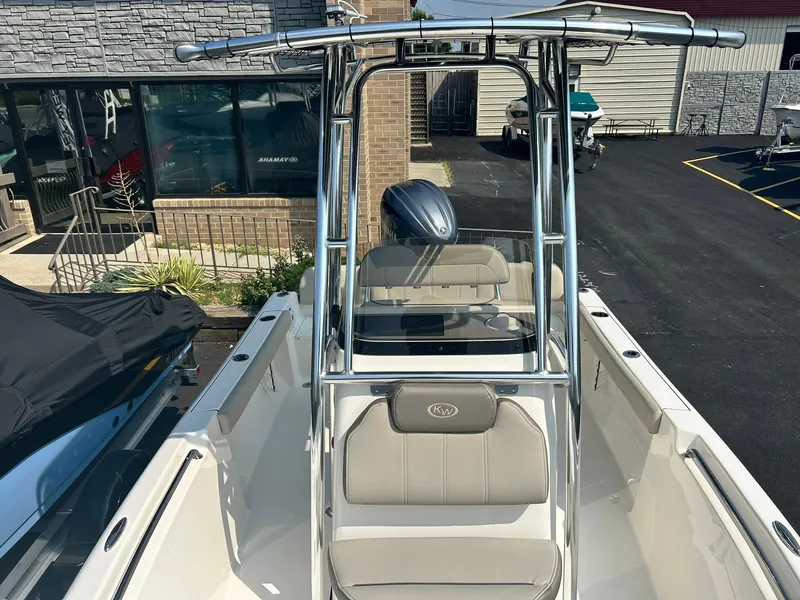 Slide: The Image of 2025 Key West 189 FS boat with T-top and seating, docked at a marina. - 10