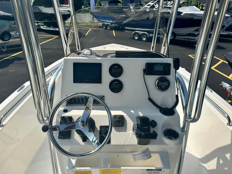 Slide: The Image of 2025 Key West 189 FS boat dashboard with steering wheel, gauges, and electronic controls. - 12