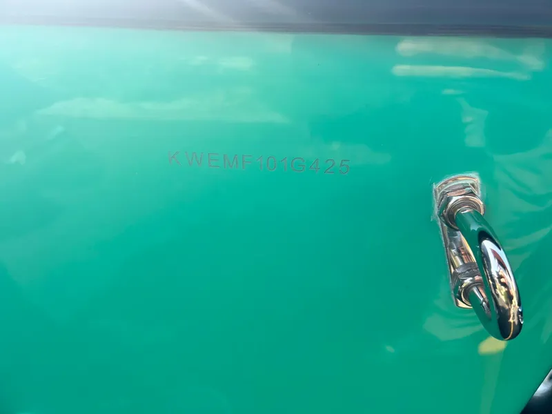 Slide: The Image of 2025 Key West 189 FS boat hull identification number (HIN) on teal surface. - 7