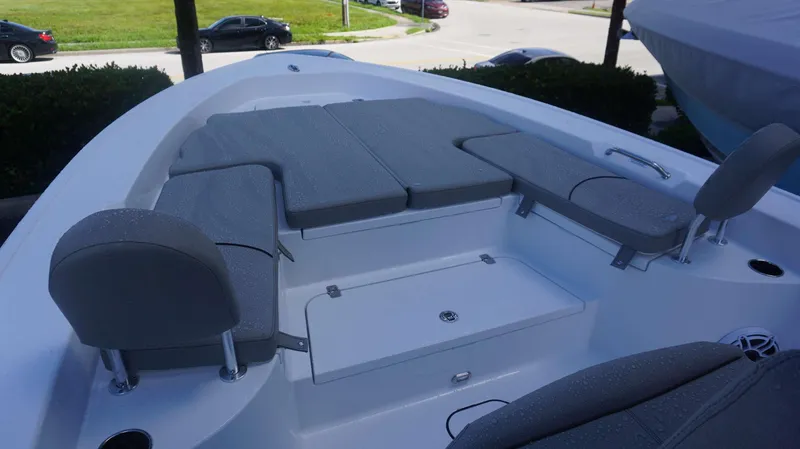 Slide: The Image of 2025 Sportsman 267 Masters boat interior with gray cushioned seating and storage compartment. - 10