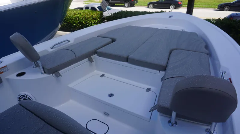 Slide: The Image of 2025 Sportsman 267 Masters boat interior with cushioned seating and storage compartments. - 11