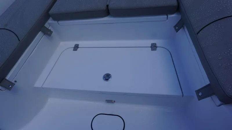 Slide: The Image of 2025 Sportsman 267 Masters boat seating area with storage compartment and cushions. - 12