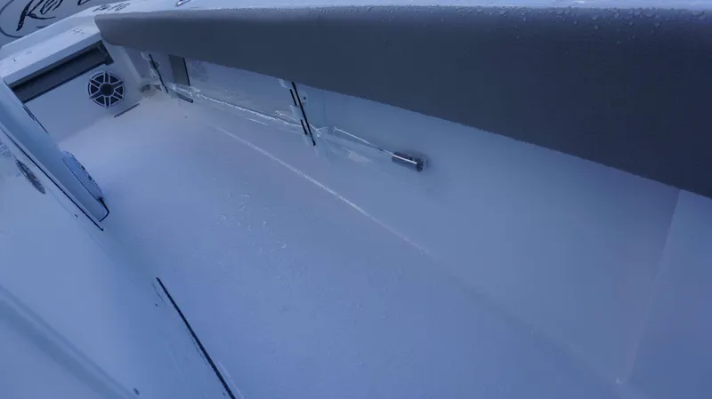 Slide: The Image of Interior view of a 2025 Sportsman 267 Masters boat, featuring seating and speaker. - 16