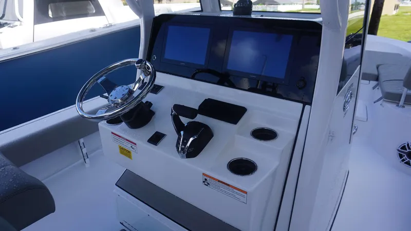 Slide: The Image of 2025 Sportsman 267 Masters boat console with dual screens and steering wheel. - 20