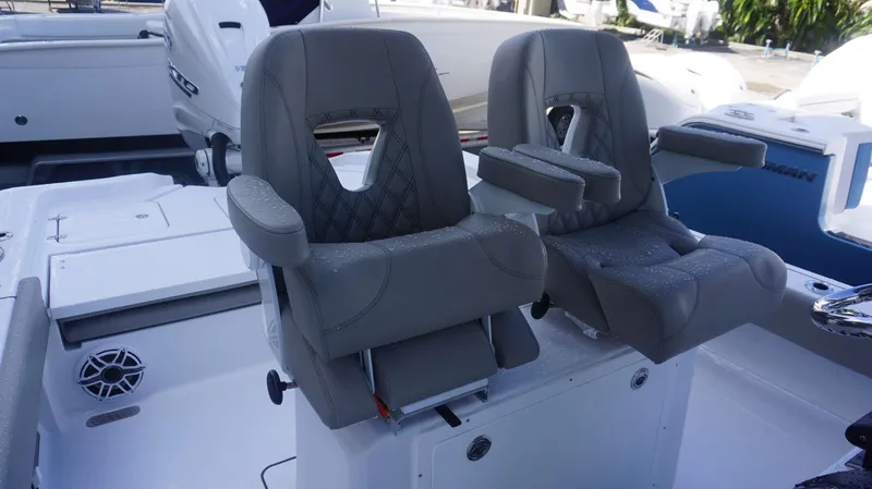 Slide: The Image of Dual captain's chairs on 2025 Sportsman 267 Masters boat, featuring sleek gray upholstery. - 21