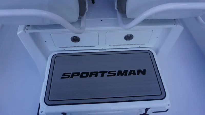 Slide: The Image of 2025 Sportsman 267 Masters boat deck with storage compartment and logo. - 26