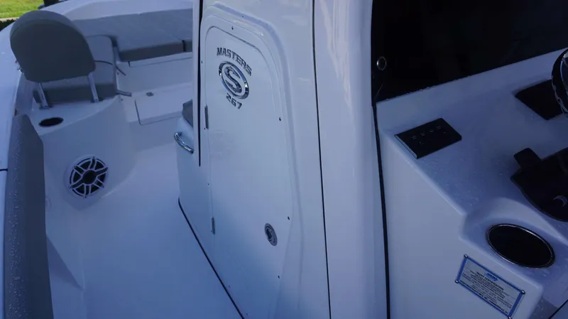 Slide: The Image of 2025 Sportsman 267 Masters boat interior, featuring seating and control panel. - 29