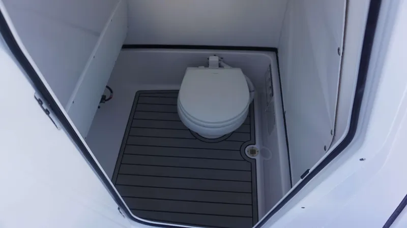 Slide: The Image of 2025 Sportsman 267 Masters boat interior with compact marine toilet. - 30