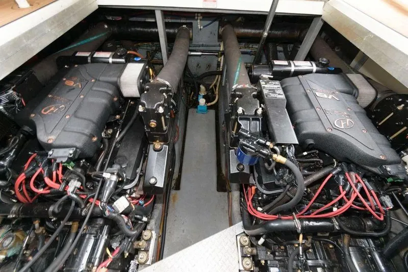 Slide: The Image of 1998 Sea Ray 370 Sundancer engine compartment with dual engines. - 11