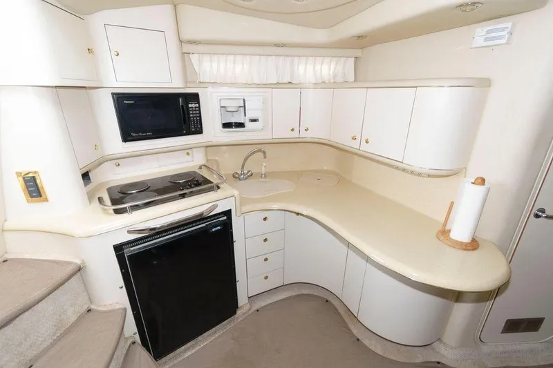 Slide: The Image of 1998 Sea Ray 370 Sundancer yacht kitchen with modern appliances and ample storage. - 13