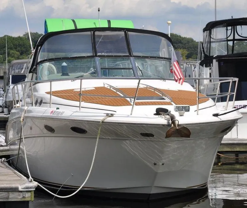 Slide: The Image of 1998 Sea Ray 370 Sundancer docked at a marina. - 2