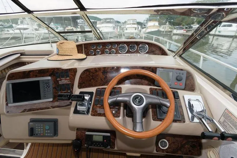 Slide: The Image of Cockpit of a 1998 Sea Ray 370 Sundancer with wooden steering wheel and navigation instruments. - 3