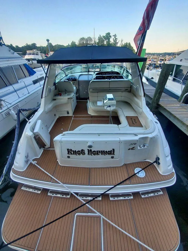 Slide: The Image of 1998 Sea Ray 370 Sundancer docked, rear view with custom deck and seating. - 6