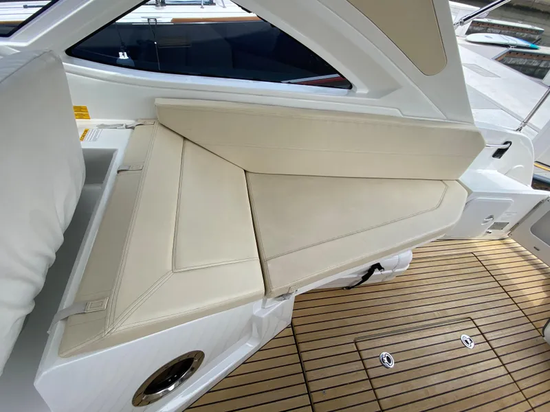 Slide: The Image of 2016 Beneteau GT35 boat interior with beige leather seating and teak flooring. - 32