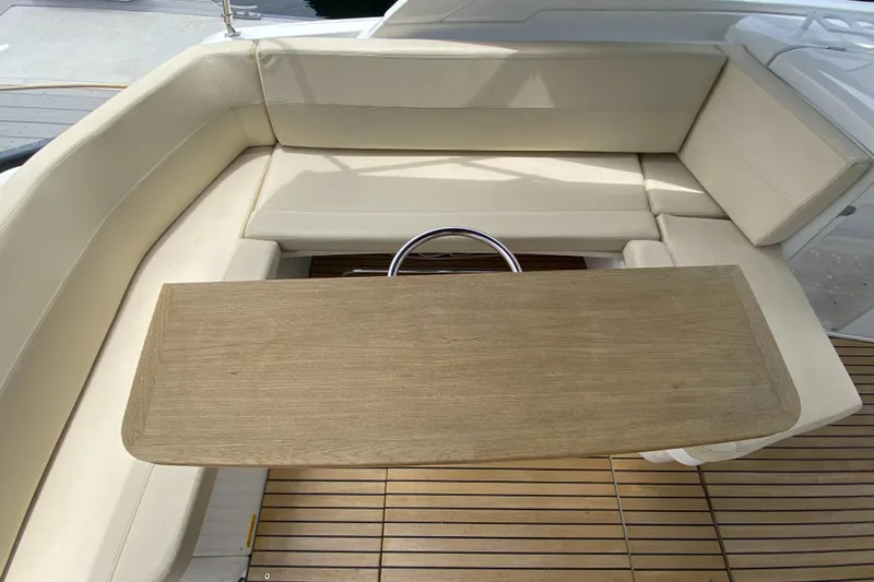 Slide: The Image of 2016 Beneteau GT35 yacht interior with beige seating and wooden table. - 34