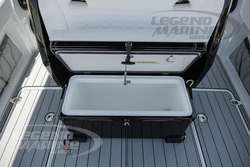Slide: The Image of 2024 Nor-Tech 340 Sport boat with open storage compartment on deck. - 25