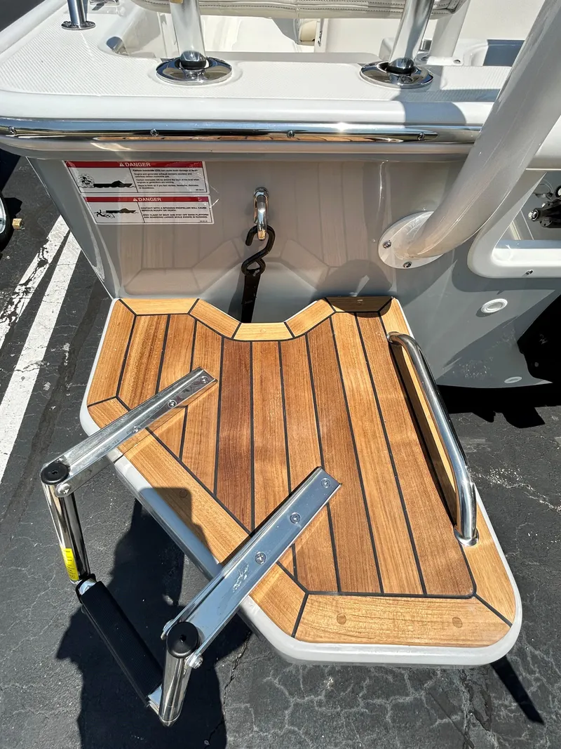 Slide: The Image of 2025 Boston Whaler 190 Montauk swim platform with teak decking and retractable ladder. - 14