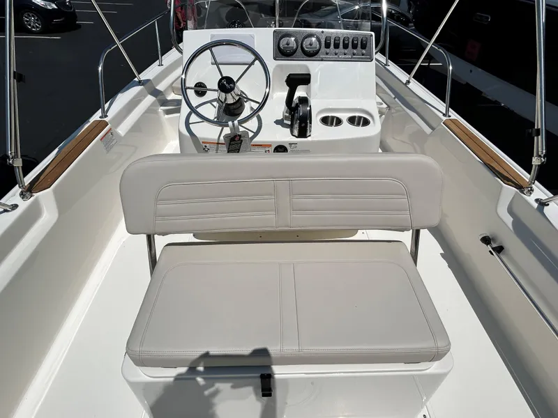Slide: The Image of Boston Whaler 190 Montauk 2025 boat interior with steering wheel and seating. - 2