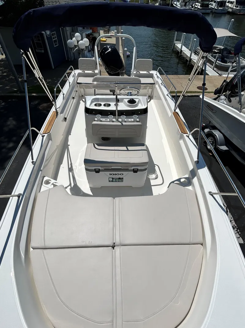 Slide: The Image of 2025 Boston Whaler 190 Montauk boat interior with seating and console. - 7