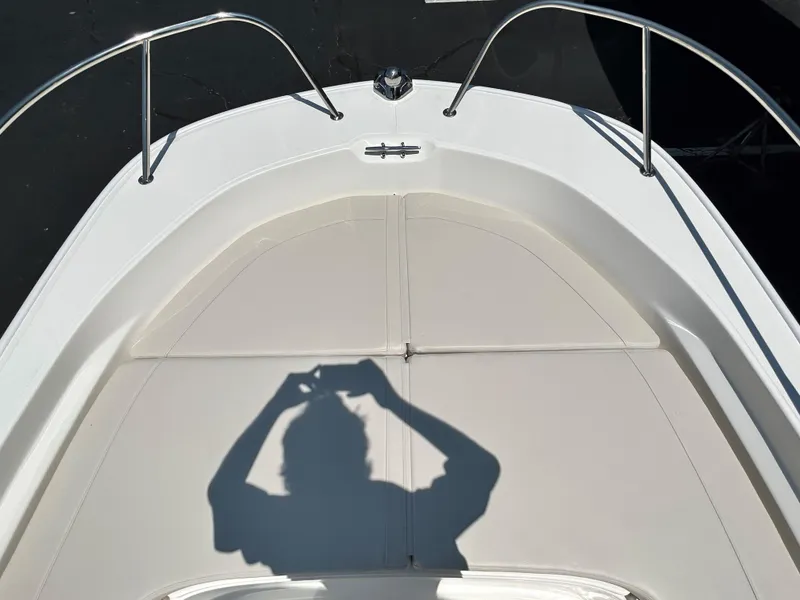 Slide: The Image of Bow of 2025 Boston Whaler 190 Montauk boat with shadow of person taking photo. - 8