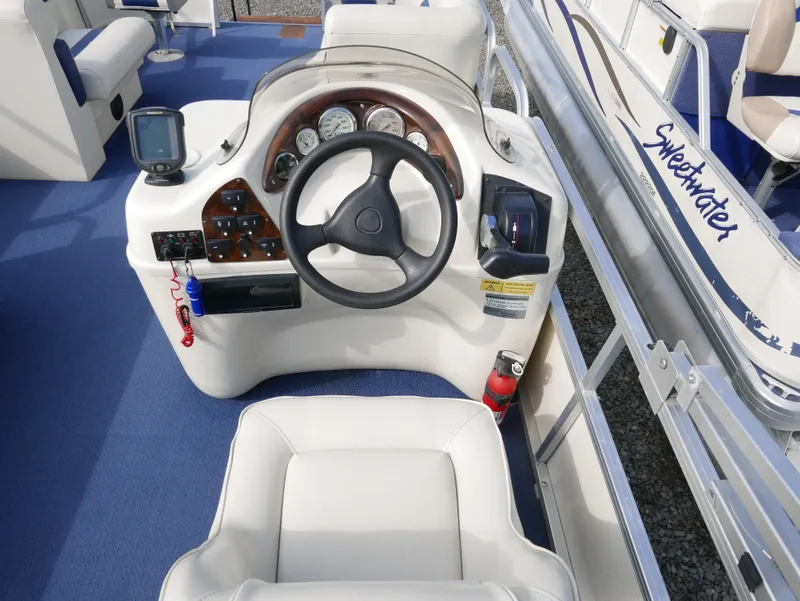 Slide: The Image of 2005 Odyssey Pontoons Millenium 2 boat dashboard and steering wheel. - 10