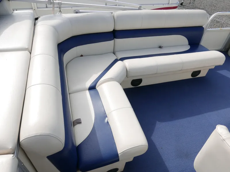 Slide: The Image of 2005 Odyssey Pontoons Millenium 2 boat interior with white and blue cushioned seating. - 11