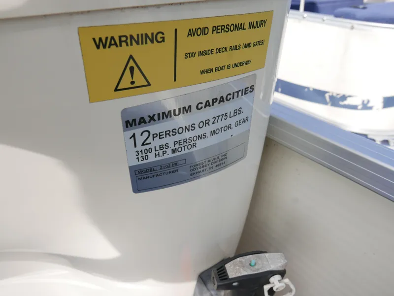 Slide: The Image of 2005 Odyssey Pontoons Millenium 2 capacity warning label, 12 persons or 2775 lbs max. - 12