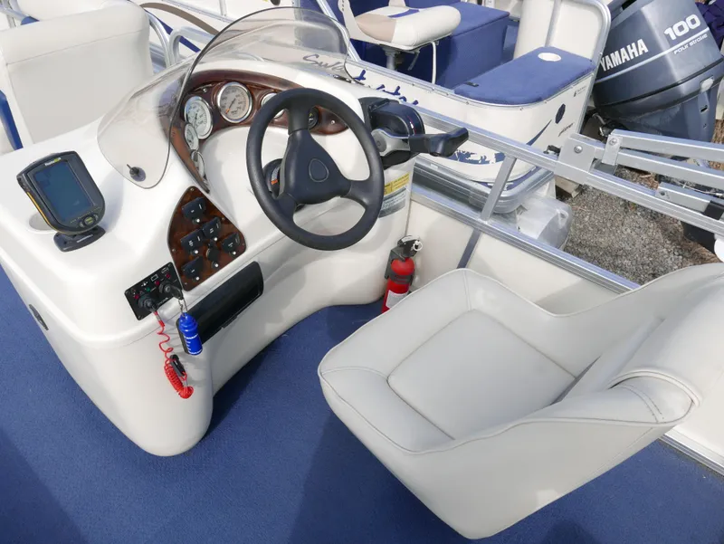 Slide: The Image of 2005 Odyssey Pontoons Millenium 2 boat cockpit with steering wheel and control panel. - 9