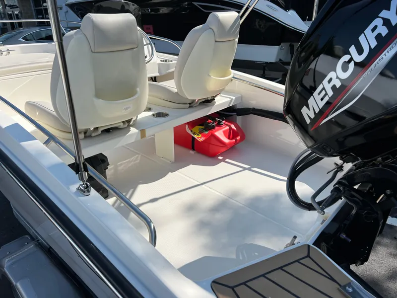 Slide: The Image of 2025 Boston Whaler 130 Super Sport boat interior with Mercury engine. - 6