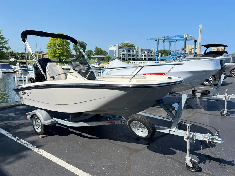 The Image of 2027 Boston Whaler 130 Super Sport boat displayed indoors with Mercury engine. - 0