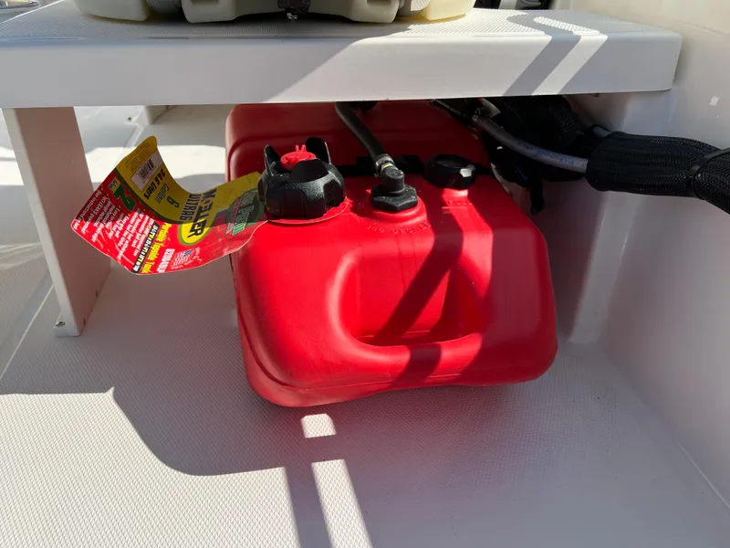 Slide: The Image of 2027 Boston Whaler 130 Super Sport boat with Mercury engine, white seating, and swim ladder. - 7