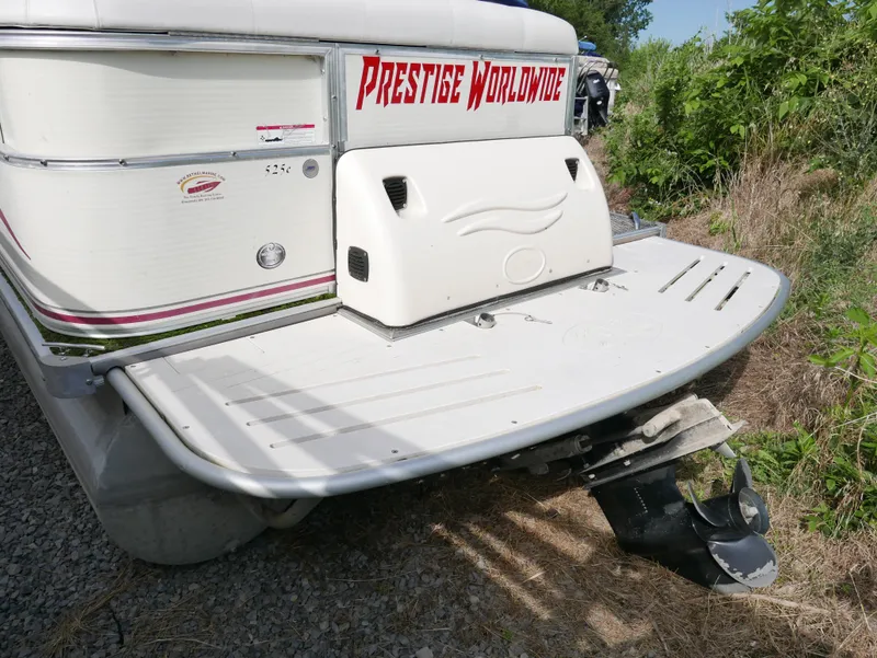 Slide: The Image of 2006 Odyssey Pontoons 525CTTI/O boat rear view with Prestige Worldwide decal. - 2