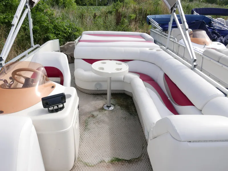 Slide: The Image of 2006 Odyssey Pontoons 525CTTI/O with white and red seating, steering console, and table. - 6