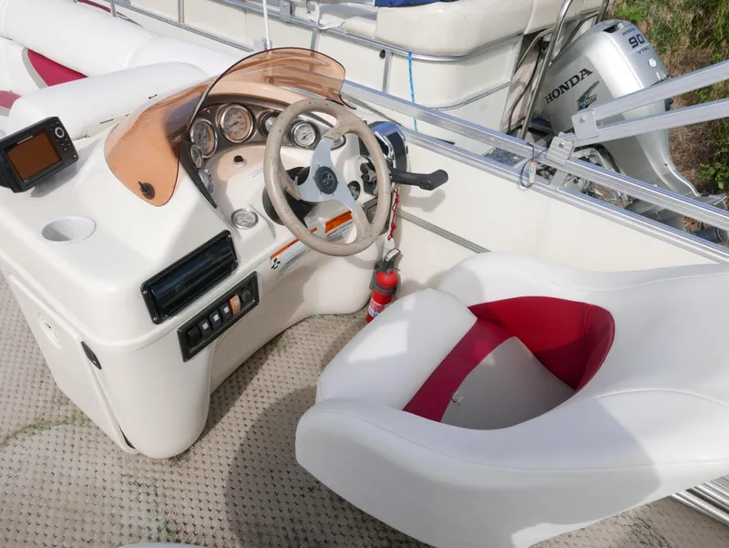 Slide: The Image of 2006 Odyssey Pontoons 525CTTI/O boat cockpit with steering wheel and controls. - 7