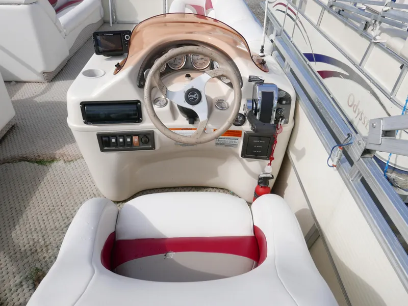 Slide: The Image of 2006 Odyssey Pontoons 525CTTI/O boat cockpit with steering wheel and control panel. - 8