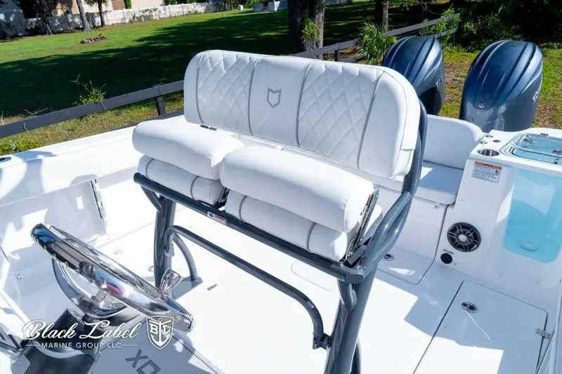 Slide: The Image of 2025 Sea Fox 268 Commander Center Console boat interior with white seating and dual engines. - 12