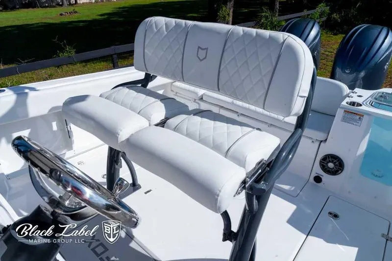 Slide: The Image of 2025 Sea Fox 268 Commander Center Console boat interior with white cushioned seating. - 13