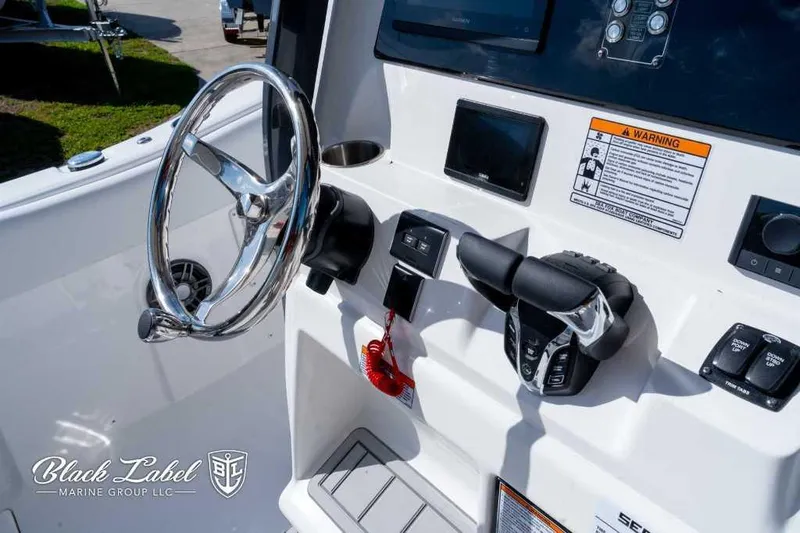Slide: The Image of 2025 Sea Fox 268 Commander Center Console helm with steering wheel and controls. - 16