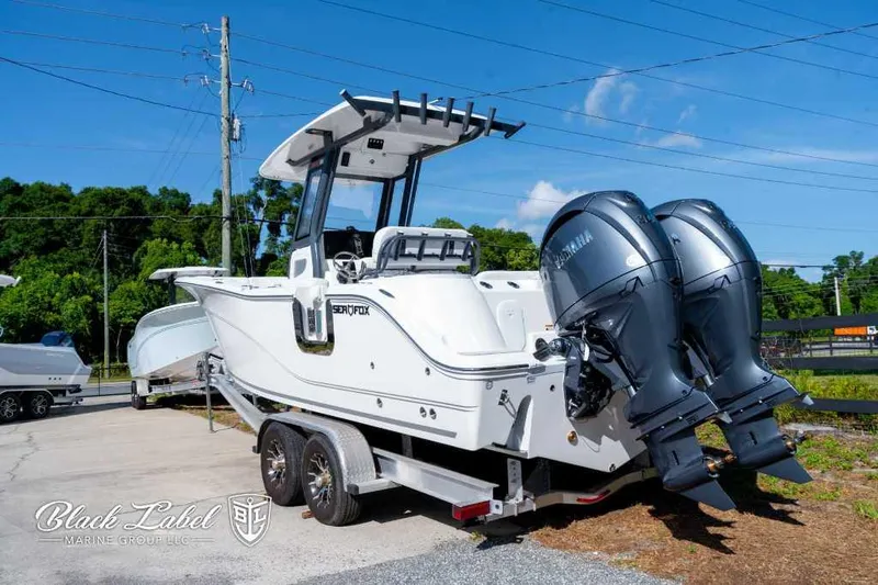 Slide: The Image of 2025 Sea Fox 268 Commander Center Console boat on trailer with twin Yamaha engines. - 2