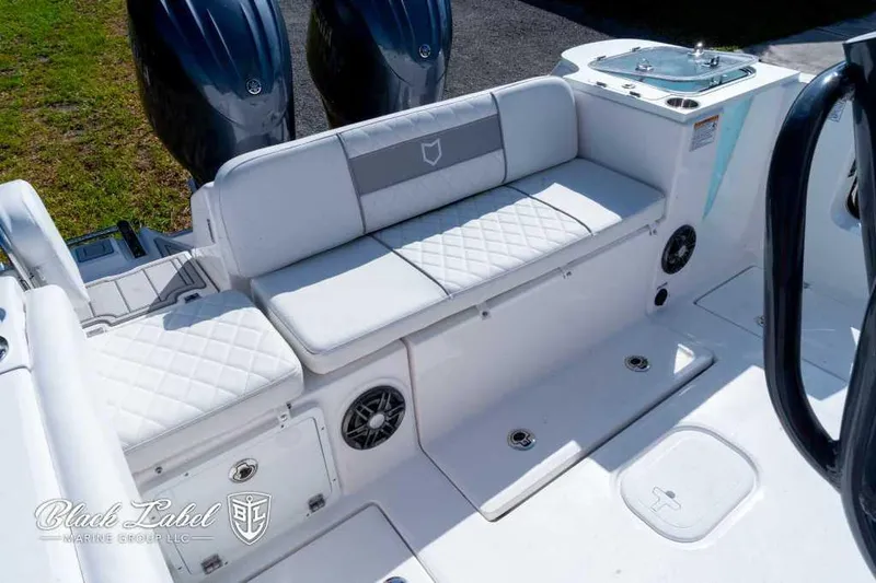 Slide: The Image of 2025 Sea Fox 268 Commander Center Console boat with cushioned seating and twin engines. - 22