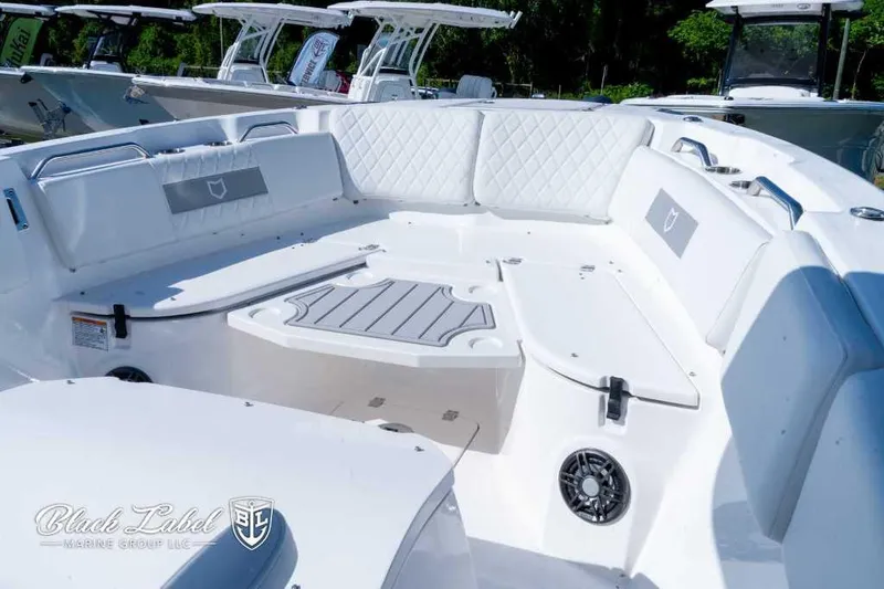 Slide: The Image of 2025 Sea Fox 268 Commander Center Console boat interior with white seating and table. - 5