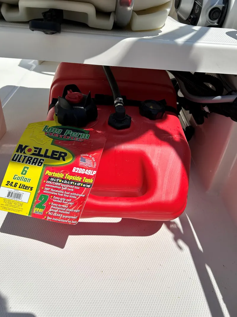 Slide: The Image of Red Moeller Ultra6 6-gallon portable fuel tank on a 2025 Boston Whaler 130 Super Sport boat. - 11