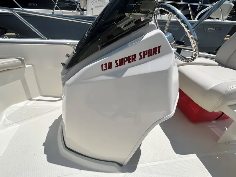 Slide: The Image of 2025 Boston Whaler 130 Super Sport boat console and steering wheel. - 6