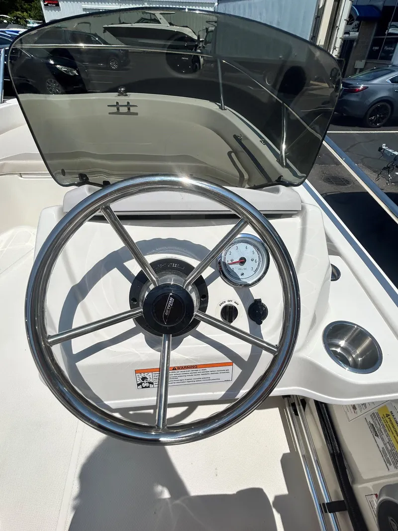 Slide: The Image of 2025 Boston Whaler 130 Super Sport steering wheel and dashboard. - 7