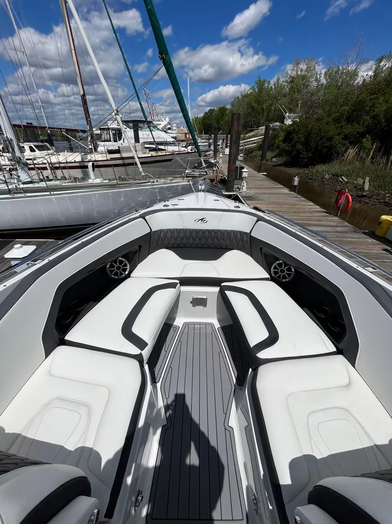 Slide: The Image of 2018 Monterey 328 Super Sport boat docked at a marina on a sunny day. - 11