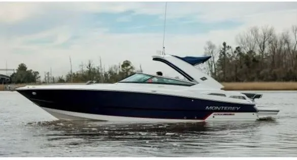 Slide: The Image of 2018 Monterey 328 Super Sport boat cruising on a calm lake. - 12